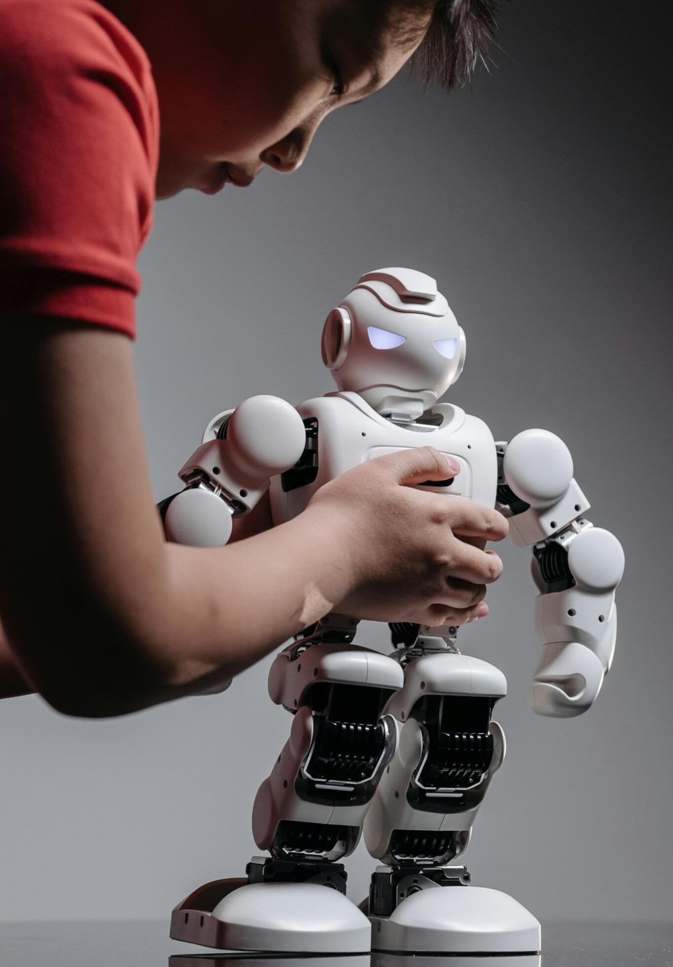 A human carefully holding a robot to show that innovators need great legal support